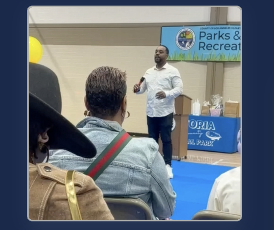 Michael Clarett speaking into a microphone at a community Parks and Recreation gathering